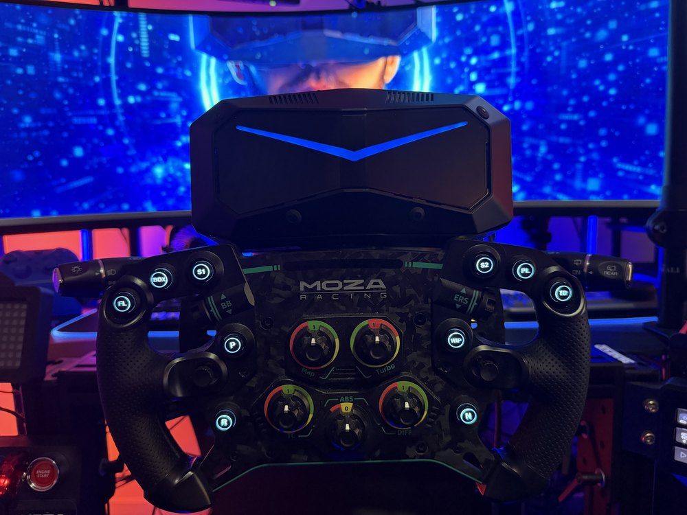 Pimax Crystal Super headset mounted in front of a Moza Racing wheel on a sim rig